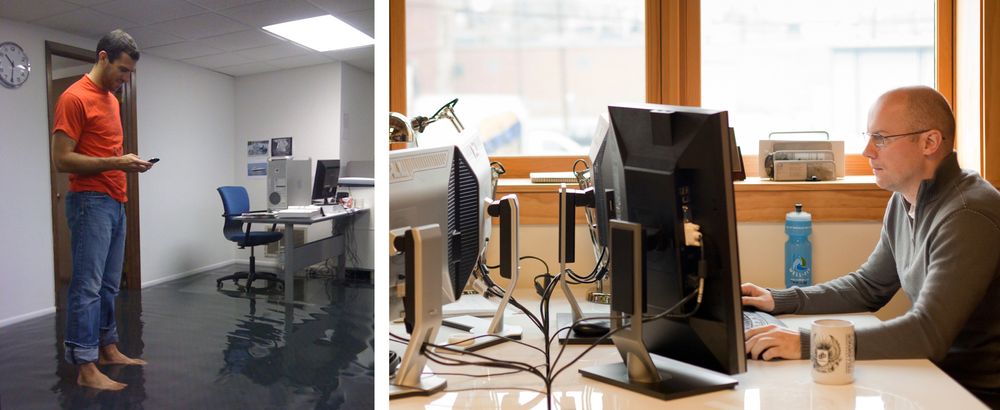 Martin standing barefoot in a flooded office and Tomas sitting at a desk in the new office